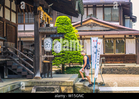 Takayama - May 26, 2019: Western traveler in a shrine in Takayama, Japan Stock Photo