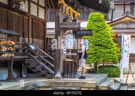 Takayama - May 26, 2019: Western traveler in a shrine in Takayama, Japan Stock Photo