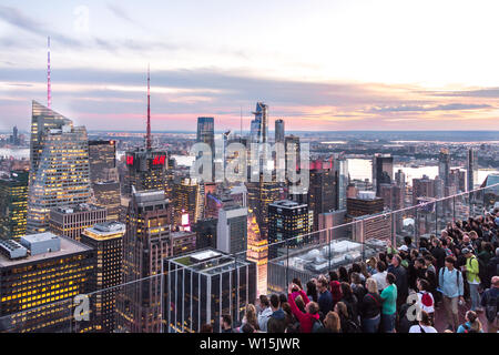 NEW YORK, USA - 17 MAY, 2019: Tourists taking pictures from rooftop on Manhattan skyscraper Stock Photo