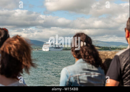 Bantry, West Cork, Ireland. 30th June, 2019. For the second time in a week, the cruise liner 'Nautica' spent the day anchored in Bantry Harbour.  She is pictured setting sail for Galway, as Bantry locals look on. Credit: Andy Gibson/Alamy Live News. Stock Photo