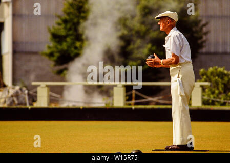 New Zealand, North Island, Rotorua. Elderly players at Rotorua bowling club. Lawn bowls. Steam in the background is from the geothermal activity in th Stock Photo