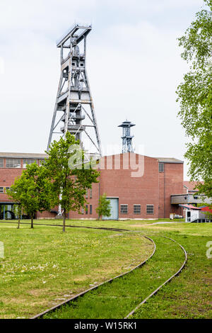A large steel shaft tower with brick buildings on the former Arenberg coal mine site in Wallers in the mining basin of Nord-Pas de Calais, France. Stock Photo