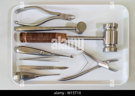 Surgical tools set or medical equipment on white tray on white laboratory worktop Stock Photo