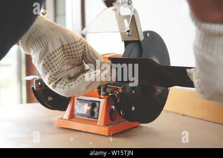 knife sharpening machine and master. Grinding machine. grinding knife using  abrasive stone Stock Photo - Alamy