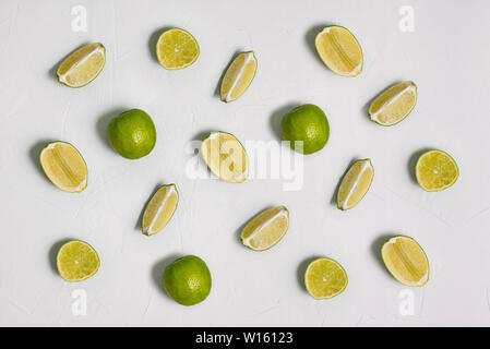 Lime on a white background. Slices of fresh citrus fruits are arranged in a row. Cooking, recipes, cosmetics. Healthy food with vitamin C. Stock Photo