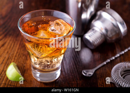 A delicious dark and stormy cocktail made with ginger beer, dark rum and lime. Stock Photo