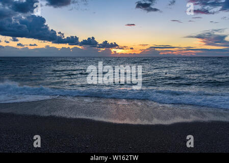 Picturesque sunset on the Calabrian beach in Italy Stock Photo