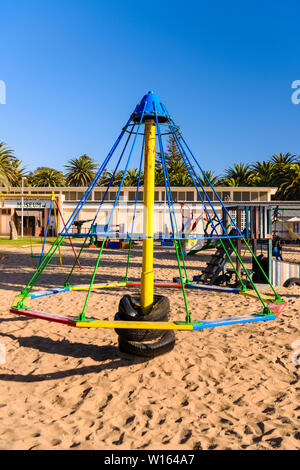 Old fashioned 'Witches Hat' playground ride.  These were banned in the 1980s in most places due to the high numbers of broken arms and legs caused by Stock Photo