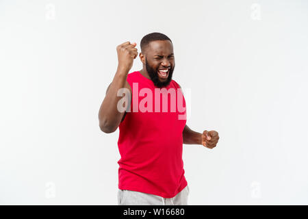 Young fitness african black man in sport wear cheering carefree and excited. Victory concept. Stock Photo