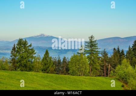 Beautiful spring mountain landscape. Green glade on the beautiful hills. Stock Photo