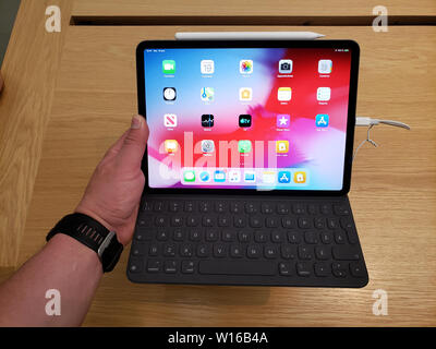 MONTREAL, CANADA - JUNE 20, 2019: Apple iPad PRO with keyboard in a hand at Apple store. Apple Inc. is an American multinational technology company he Stock Photo