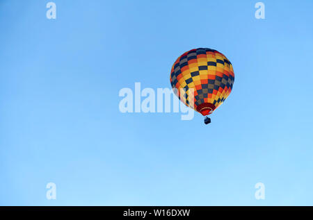 Hot air colourful baloon over blue sky. Traveling by balloon Stock Photo