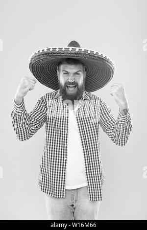 Join fest. Mexican culture concept. Celebrate mexican holiday. Mexican bearded guy ready to celebrate. Customs and traditions. Man wear sombrero mexican hat. Vacation travel festival and holidays. Stock Photo