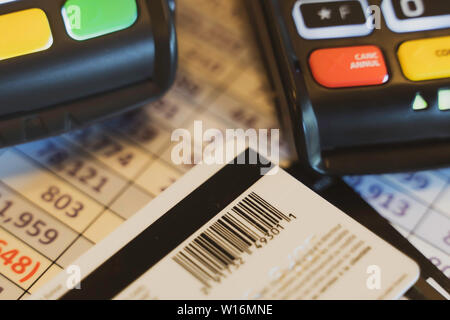 Credit Card Machine on spreadsheet with credit cards Stock Photo