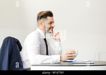 Handsome businessman having break during work in office Stock Photo