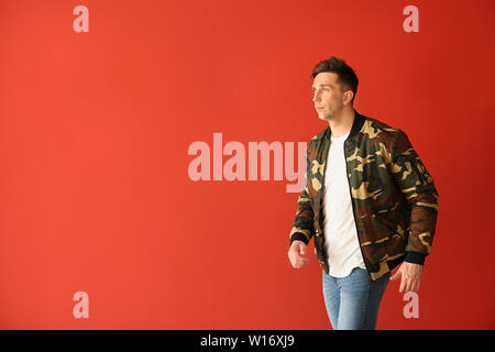 Fashionable young man on color background Stock Photo