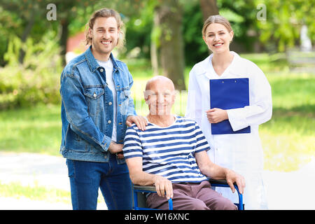 Young man visiting his father in nursing home Stock Photo