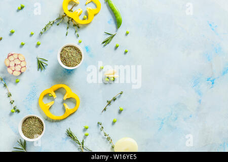 Fresh herbs with vegetables and spices on color background Stock Photo