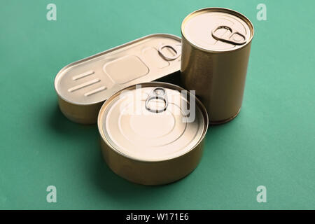 Tin cans with food on color background Stock Photo