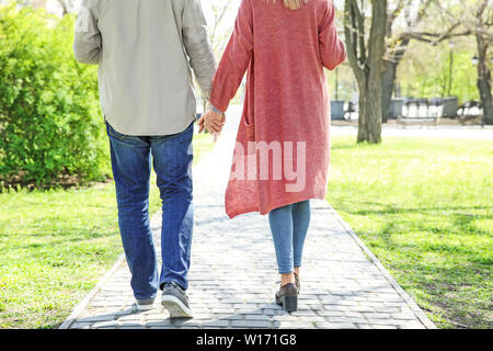 Happy elderly couple walking in park Stock Photo