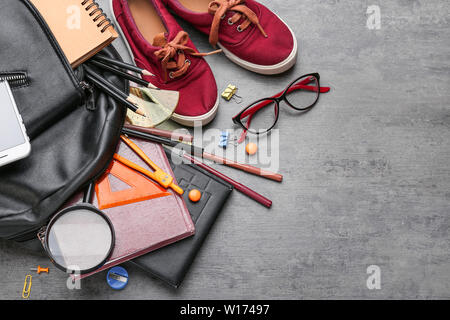 Different school stationery, shoes and backpack on grey background Stock Photo