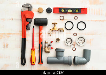 Set of plumbing tools on white wooden background Stock Photo