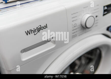Lodz, Poland, July 2018 inside Saturn electronic store, free-standing Whirlpool washing machine on display for sale, produced by Whirlpool, logo, sign Stock Photo