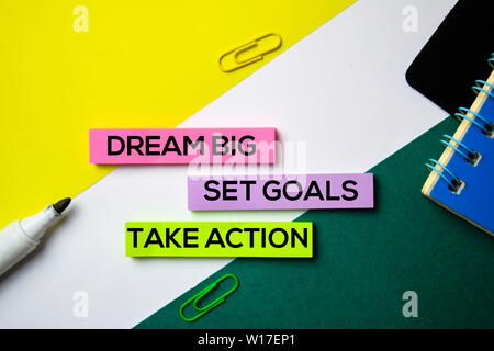 Dream Big. Set Goals. Take Action text on sticky notes with office desk concept Stock Photo