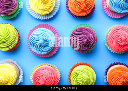 Sweet tasty cupcakes on color background Stock Photo