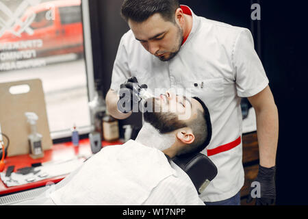 Stylish man sitting in a barbershop Stock Photo