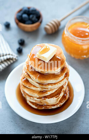 Stack Of Fluffy Buttermilk Pancakes With Butter And Syrup On White Plate. Tasty Sweet Breakfast Food Stock Photo