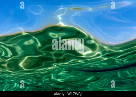 Summer time under the sea ocean water with a ray of sunlight from the surface for a background concept design
