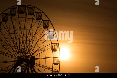 Ferris wheel and sky at sunset on the foreshore in St Kilda, Melbourne, Australia. Stock Photo