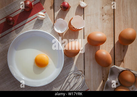 Eggs lay on wooden trays and have broken eggs. Stock Photo