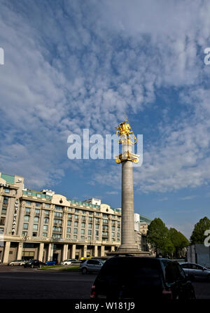 Freedom Monument depicting St. George slaying the dragon, sculpted in granite and gold, stands in front of the Marriott Hotel, Tbilisi, Georgia. Stock Photo