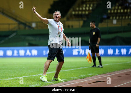 Head coach Dragan Stojkovic of Guangzhou R&F celebrates as he watches his players scoring against Henan Jianye in their 15th round match during the 2019 Chinese Football Association Super League (CSL) in Guangzhou city, south China's Guangdong province, 29 June 2019. Guangzhou R&F defeated Henan Jianye 2-0. Stock Photo