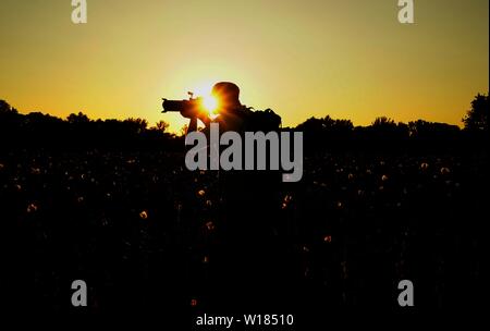 Silhouette of a photographer looking for adventure. Some thing you cannot desribe, you have to feel them. Stock Photo
