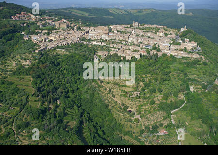AERIAL VIEW. Picturesque medieval hilltop town in Val d'Orcia. Montalcino, Province of Siena, Tuscany, Italy. Stock Photo