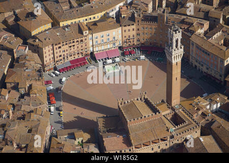 AERIAL VIEW. The Torre del Mangia (height: 87 meters) overlooking the Piazza del Campo. Siena, Province of Siena, Tuscany, Italy. Stock Photo