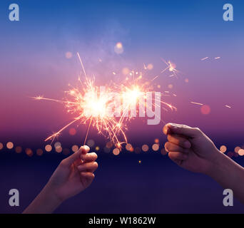 Couple holding a sparklers on the beach Stock Photo