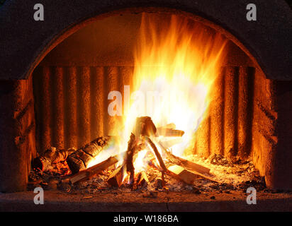 Fireplace with fire at night - outdoor shot Stock Photo