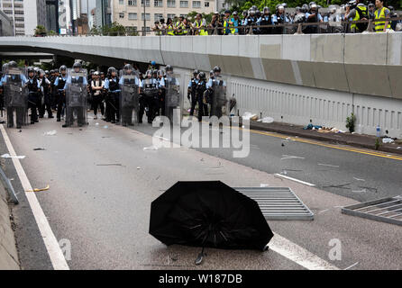 Hong Kong, China. 01st July, 2019. Riot police officers seen with riot gears during the standoff. Thousands of anti government protesters faced off with riot police and occupy major roads around the Hong Kong government complex during the 22nd anniversary of Hong Kong return to Chinese rule. Credit: SOPA Images Limited/Alamy Live News Stock Photo