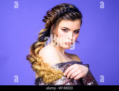 Beauty salon hairdresser art. Girl makeup face braided long hair. French braid. Professional hair care and creating hairstyle. Braided hairstyle. Beautiful young woman with modern hairstyle. Stock Photo