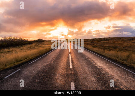 Majestic Sunset over a  deserted road in Iceland in Autumn Stock Photo