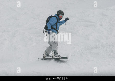 SIBIU, ROMANIA - March 13, 2010: Male snowboarder in the Fagaras mountains. Stock Photo