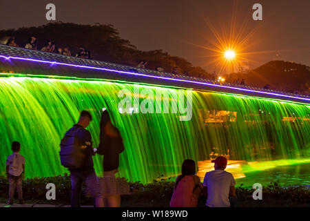 People enjoying the Starlight Bridge or anh sao bridge in phu my hung district of Ho Chi Minh City Vietnam. It is a solarpowered illuminated waterfall