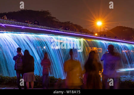 People enjoying the Starlight Bridge or anh sao bridge in phu my hung district of Ho Chi Minh City Vietnam. It is a solarpowered illuminated waterfall