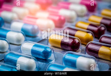 Selective focus on blue-white capsule pills in blister pack. Pharmaceutical industry. Drug package. Pharmaceutics concept. Drug use in hospital Stock Photo