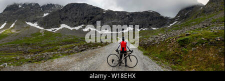 Female cyclist on private toll road through Vengedalen, close to Andalsnes, Norway. Stock Photo
