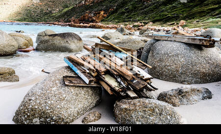 Driftwood is stacked on the rocks to dry at South Africa's Smitswinkel Bay on the Cape Peninsula's False Bay coastline, near the city of Cape Town Stock Photo